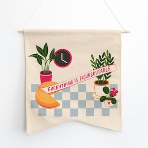 May include: A beige canvas wall tapestry with a checkered pattern and the text "EVERYTHING IS FIGUREOUTABLE" in a red banner. The tapestry features three potted plants, a fortune cookie, and a clock.