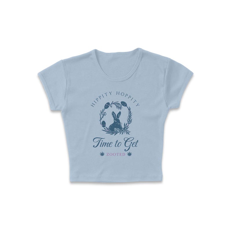 May include: Light blue cropped t-shirt with a graphic of a rabbit in a wreath with the text "Hippity Hoppity Time to Get Zooted".
