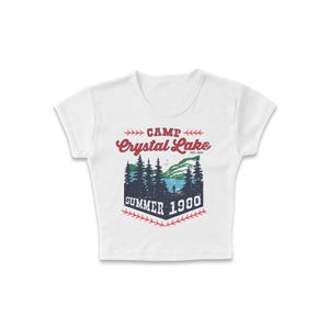 May include: White crop top with a graphic design featuring the words "Camp Crystal Lake Summer 1980." The design includes a lake scene with trees and a person. The text is in red and blue.
