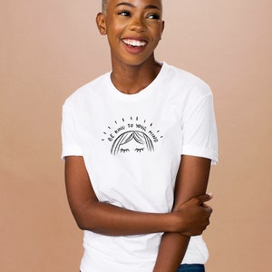 May include: White t-shirt with a black graphic that says "Be kind to your mind" with a stylized drawing of a woman's face with closed eyes.