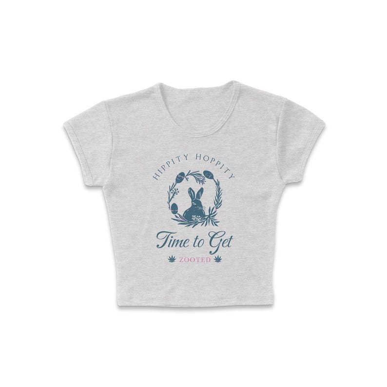 May include: A gray cropped t-shirt with a blue bunny rabbit graphic inside a wreath with the text "Hippity Hoppity Time to Get Zooted".