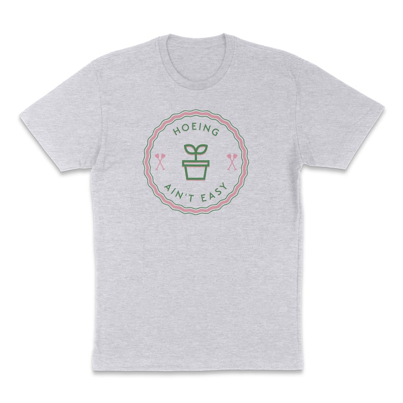 May include: A heather grey t-shirt with a green and pink graphic that says "Hoeing Ain't Easy" with a plant in a pot and two crossed gardening tools.