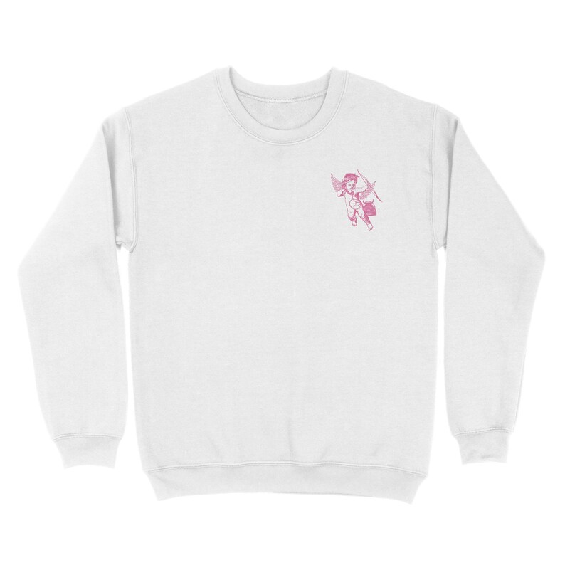 May include: White sweatshirt with a pink embroidered image of a cherub holding a bow and arrow.