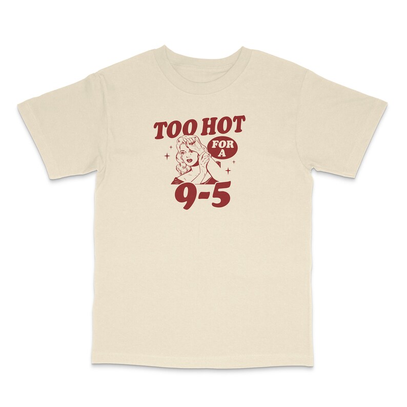 May include: A beige t-shirt with a red graphic of a woman with the text "Too Hot For A 9-5"