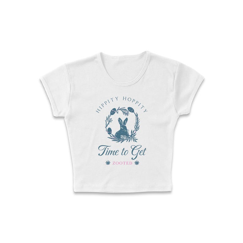 May include: White cropped t-shirt with a blue graphic of a rabbit in a wreath with the text "Hippity Hoppity Time to Get Zooted".
