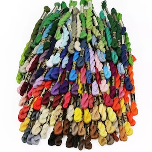 May include: A large collection of embroidery floss spools in a variety of colors, including red, orange, yellow, green, blue, purple, pink, brown, and black.