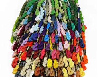 May include: A large collection of embroidery floss spools in a variety of colors, including red, orange, yellow, green, blue, purple, pink, brown, and black.
