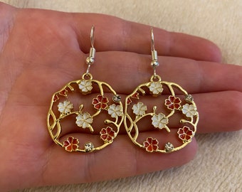 Silver dangle/ drop earrings with reddy orange flowers and diamanté charms, flower earrings, circular flower earrings