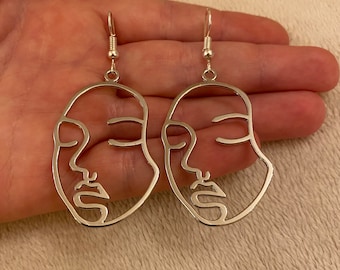 Silver dangle/ drop earrings with large silver face charms, silver face earrings, statement earrings, abstract earrings