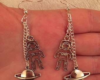 Silver dangle/ drop earrings with flying astronaut and planet charms, astronaut earrings, planet earrings, space earrings