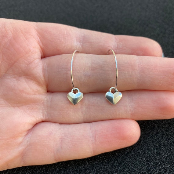 Silver hoop earrings with heart charm discount