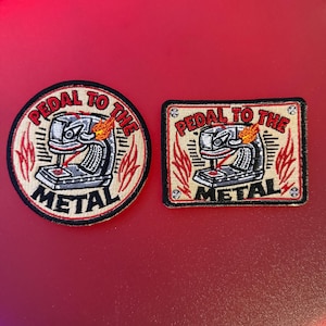 May include: Two embroidered patches, one circular and one rectangular, featuring a sewing machine graphic with flames and the text "PEDAL TO THE METAL" in red and black. The design includes a beige background with black borders and stitching.