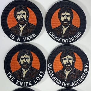 May include: A collection of eight circular patches featuring a portrait of a man with a beard in an orange circle, surrounded by black fabric. Each patch has a different phrase, including "Beats Odds With Fists" and "The Snake Died."