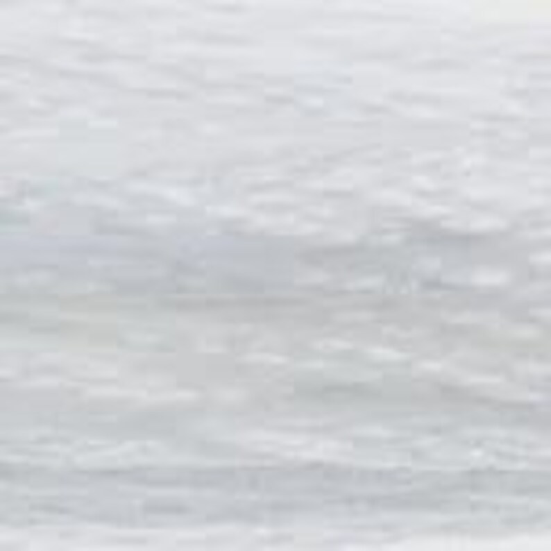 May include: A close-up view of a white, textured surface. The surface appears to have a subtle, rippled pattern, creating a sense of depth and visual interest. The lighting is soft, highlighting the texture and variations in tone.