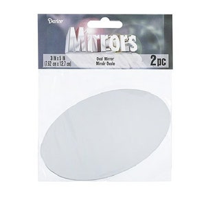 May include: A package of two oval mirrors. The package reads "Mirrors" and "3 IN x 5 IN (7.62 cm x 12.7 cm)". The mirrors are white and oval-shaped. The brand name "Darice" is visible at the top of the package.