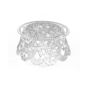 May include: A clear plastic cake stand with a round top and a decorative base. The base features a delicate floral design.