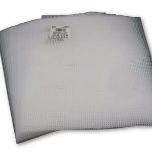 May include: A stack of white plastic canvas sheets, each measuring 10.5 inches by 13.5 inches (26.7 cm x 34.3 cm).