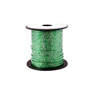 May include: A spool of green and silver metallic ribbon. The ribbon is tightly wound on a black cardboard spool. The ribbon has a textured, reflective surface, and the spool is set against a white background.