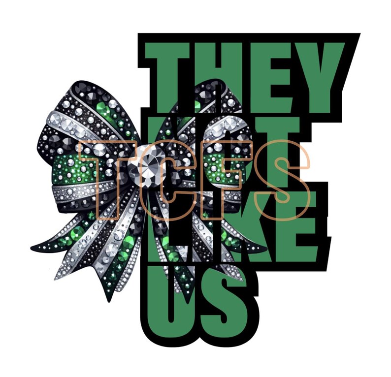 May include: Green and black cheer bow with rhinestones and the text "They don't like us" in green letters with black outlines.