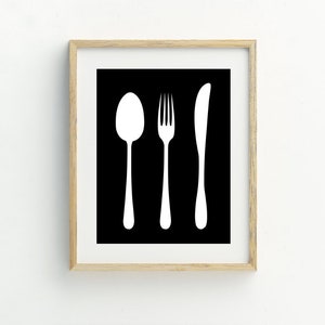 May include: A framed black and white print of a fork, knife, and spoon silhouette.
