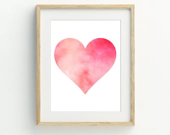 May include: A framed print of a watercolor heart in shades of pink and peach. The heart is centered on a white background.