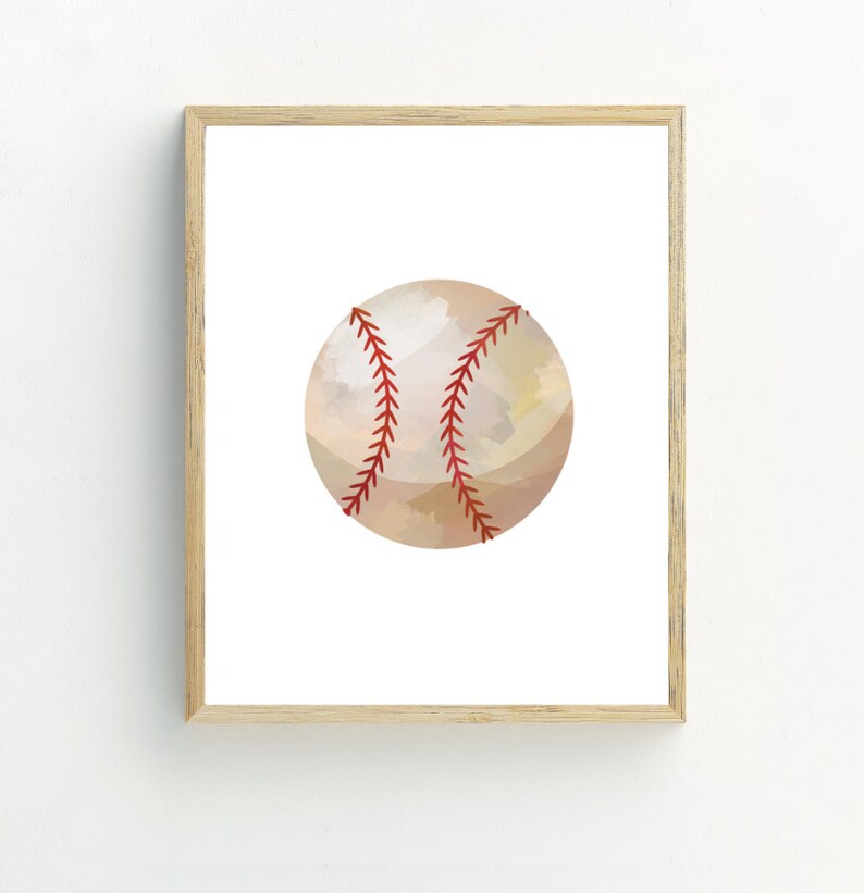 May include: A framed print of a watercolor illustration of a baseball. The baseball is beige with red stitching.