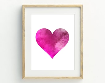May include: A framed print of a pink watercolor heart on a white background.