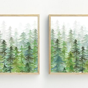 May include: Two framed watercolor paintings of a forest scene with green trees in a foggy setting.