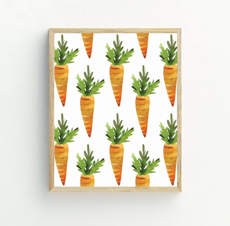 May include: A digital print featuring a repeating pattern of orange carrots with green leafy tops on a white background. The print is framed in a light wood frame.