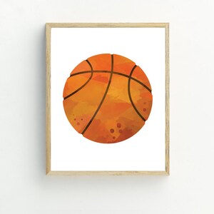 May include: A framed print of a watercolor illustration of an orange basketball with black lines.