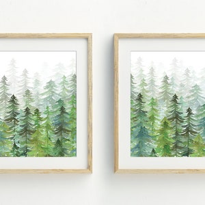 May include: Two framed watercolor paintings of a forest scene with green trees and a white background.