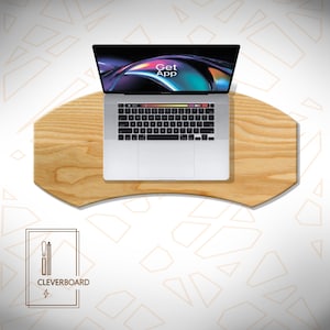 May include: A laptop computer with a black keyboard and a screen displaying the words "Get App" sits on a light-colored wooden desk. The desk has a unique, curved shape. The logo for "Cleverboard" is in the lower left corner.