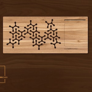 May include: A wooden laptop stand with a cutout design and the word "CLEVERBOARD" engraved on the front. The stand is made of light brown wood and has a natural finish.