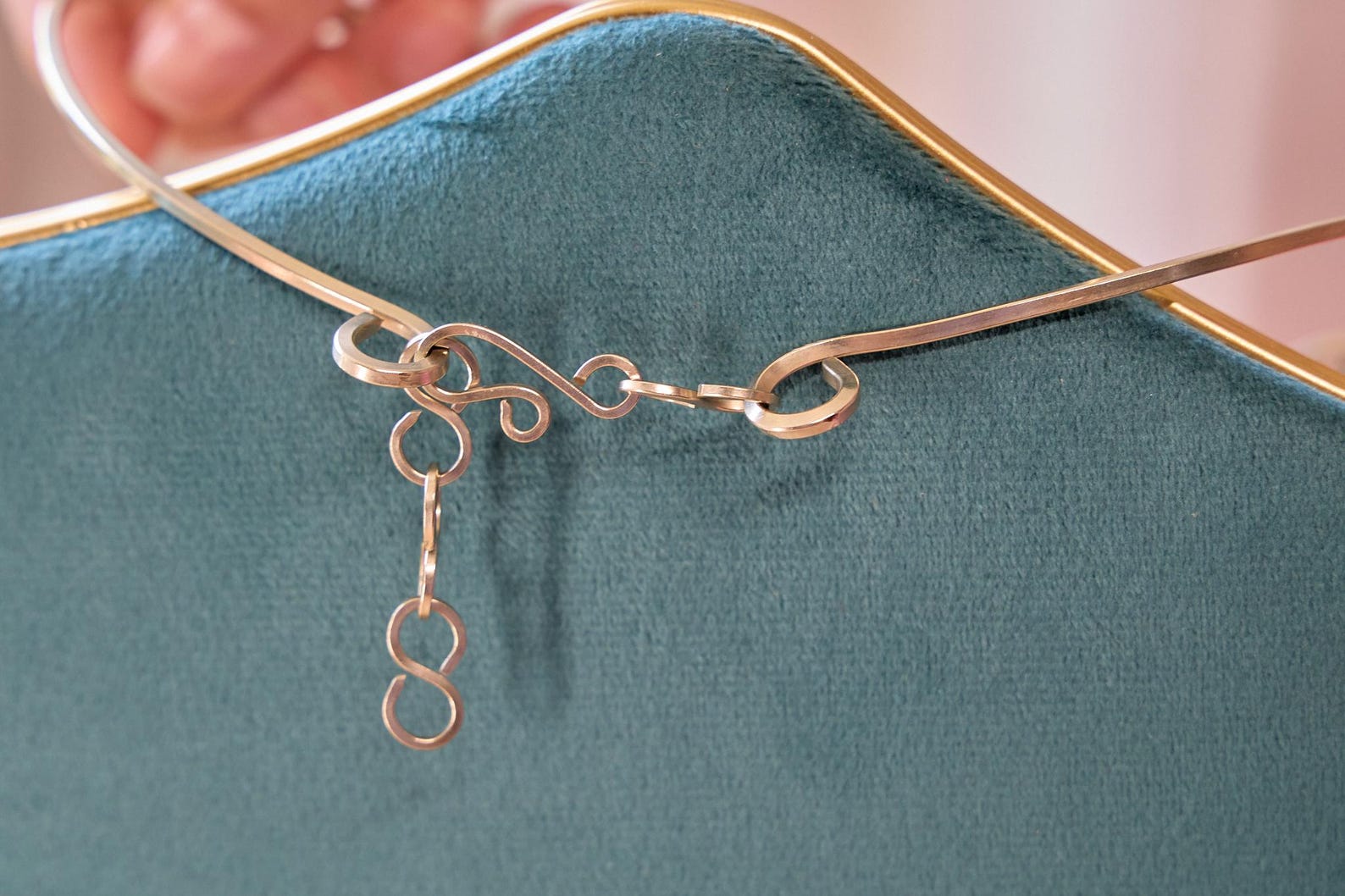 Close-up of handmade silver scroll clasp on black obsidian statement necklace.