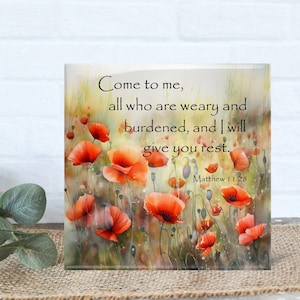 May include: A square decorative art piece featuring a watercolor painting of red poppies. The artwork includes the text "Come to me, all who are weary and burdened, and I will give you rest. Matthew 11:28."