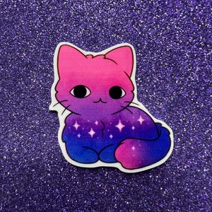 May include: A sticker of a cartoon cat with a pink and blue gradient, resembling the bisexual pride flag. The cat has a starry pattern on its chest and is sitting on a purple glitter background.