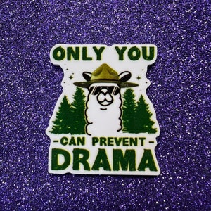 May include: A white sticker with a llama wearing a ranger hat and sunglasses. The llama is surrounded by green trees. The text on the sticker reads "Only You -Can Prevent- Drama".