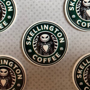 May include: Four round stickers with a black and white illustration of Jack Skellington from the Nightmare Before Christmas. The stickers have a green background and the text "Skellington Coffee" in white.