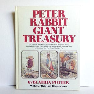 May include: A hardcover book titled "PETER RABBIT GIANT TREASURY" with illustrations by Beatrix Potter. The cover features the title in red letters and three illustrations of Peter Rabbit and other characters.