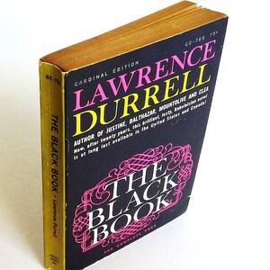 May include: A vintage paperback book titled "The Black Book" by Lawrence Durrell. The cover is black with pink and white text, and the edges of the pages are gold. The book is a Cardinal Edition.
