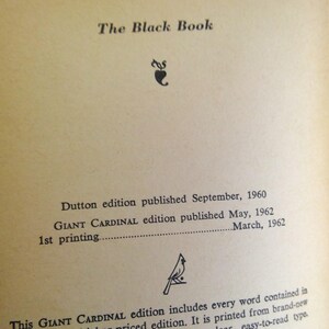 May include: An open book page with the title "The Black Book" at the top. Below the title are details about the Dutton and Giant Cardinal editions, including publication dates of 1960 and 1962. The page has a vintage, aged appearance.