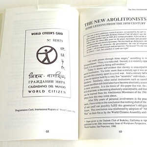 Puede incluir: Libro abierto que muestra una Tarjeta de Ciudadano del Mundo en la p&aacute;gina izquierda, con texto en varios idiomas y un gr&aacute;fico circular. La p&aacute;gina derecha presenta el texto "The New Abolitionists" y analiza lecciones del siglo XIX.