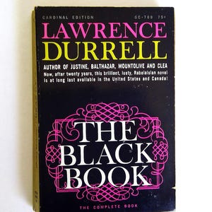 May include: A vintage paperback book titled "The Black Book" by Lawrence Durrell. The cover is black with pink and yellow text. The book is a Cardinal Edition and includes the text "The Complete Book".