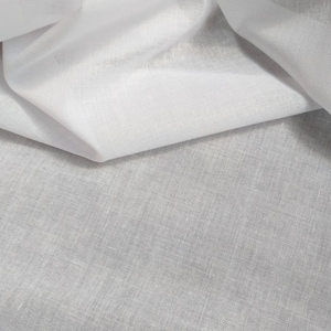 May include: White fabric with a smooth, silky texture. The fabric is folded in half, revealing a slightly textured underside.