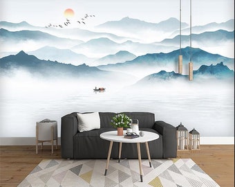 May include: A black couch with a gray throw pillow sits in front of a wall mural depicting a misty mountain landscape with a small boat on a lake. The mural is painted in shades of blue and gray.
