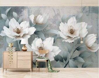 May include: A wall mural featuring a large floral design with white flowers and green leaves on a light blue and gray background.