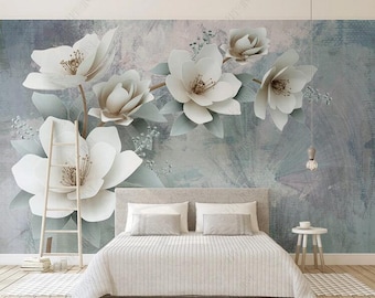 May include: A bedroom with a white bed and a white ladder leaning against the wall. The wall is painted a light blue and features a large mural of white flowers with green leaves.