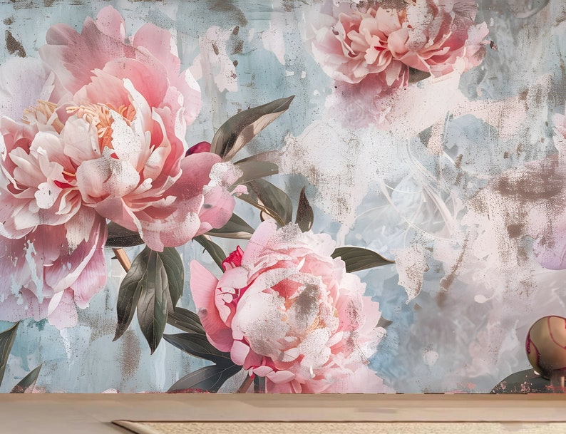 Op de afbeelding: Een vintage-stijl bloemenbehang met een verweerde, textuurrijke achtergrond. Het behang heeft grote roze pioenen met groene bladeren.