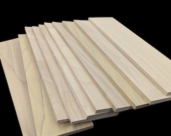 May include: A stack of unfinished, light brown wood planks. The planks are arranged in a staggered pattern, with the top plank extending furthest to the right. The planks are smooth and have a natural wood grain.