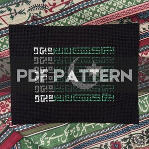 May include: Black rectangular textile with white and green geometric patterns. The text "PDF PATTERN" is centered on a black band. The background features a colorful patterned fabric.
